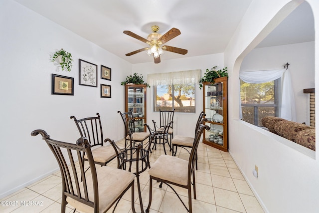 5760 S Stewart Blvd, Tucson, AZ 85706 - dining area with light tile patterned floors, healthy amount of natural light, a ceiling fan, and arched walkways