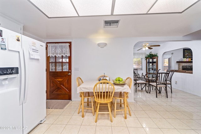 5760 S Stewart Blvd, Tucson, AZ 85706 - dining space featuring light tile patterned flooring, a ceiling fan, and arched walkways