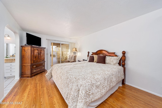 5760 S Stewart Blvd, Tucson, AZ 85706 - bedroom featuring arched walkways, light wood-style floors, and access to outside