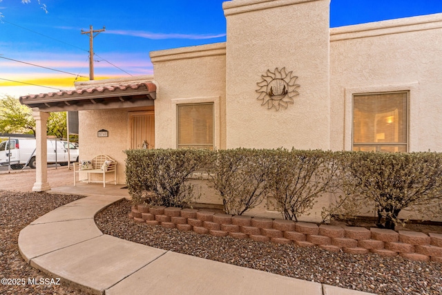 5760 S Stewart Blvd, Tucson, AZ 85706 - view of exterior entry featuring stucco siding, a patio area, and a tiled roof