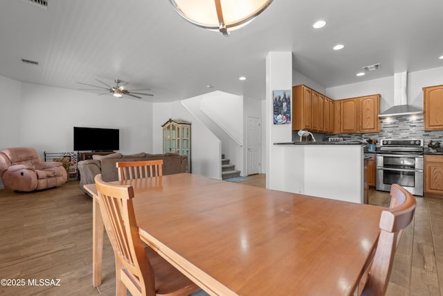 977 S Limestone St, Benson, AZ 85602 - dining area featuring ceiling fan, recessed lighting, stairway, and light wood-style floors