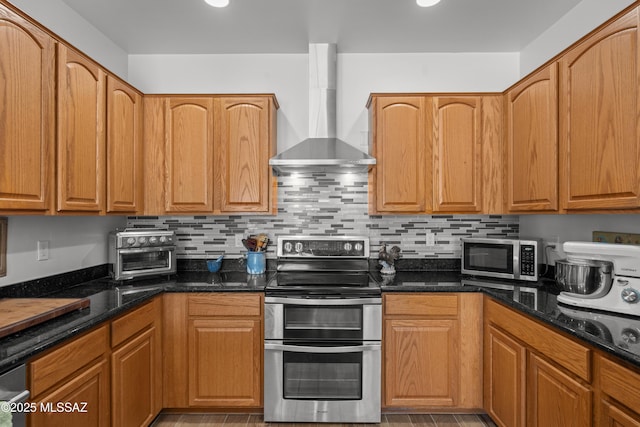 977 S Limestone St, Benson, AZ 85602 - kitchen with wall chimney range hood, appliances with stainless steel finishes, dark stone countertops, tasteful backsplash, and recessed lighting