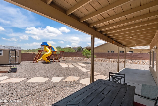 977 S Limestone St, Benson, AZ 85602 - fenced backyard with a patio, a shed, and a playground