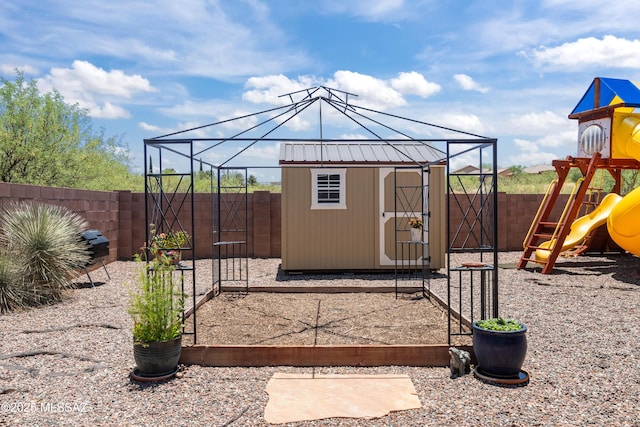 977 S Limestone St, Benson, AZ 85602 - fenced backyard featuring a playground, a gate, and a storage unit
