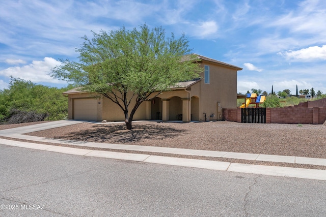 977 S Limestone St, Benson, AZ 85602 - view of front facade with stucco siding, an attached garage, and driveway