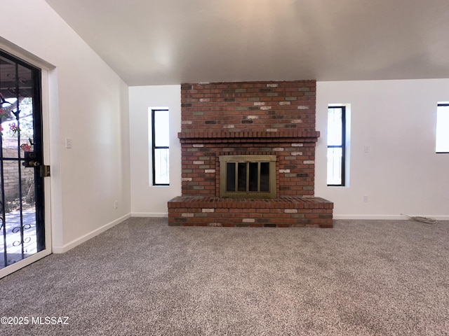 1339 W Pastime Rd, Tucson, AZ 85705 - unfurnished living room with carpet, a brick fireplace, and vaulted ceiling