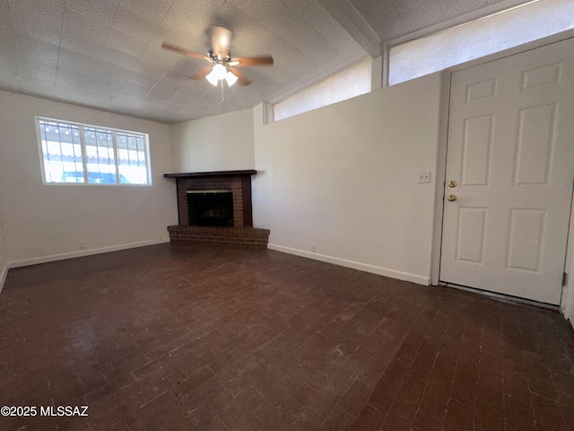 1339 W Pastime Rd, Tucson, AZ 85705 - unfurnished living room featuring a ceiling fan and a fireplace