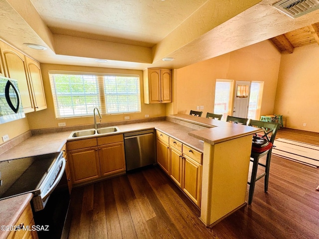 10487 E Turkey Creek Rd, Pearce, AZ 85625 - kitchen with stainless steel dishwasher, dark wood-style floors, electric range, a peninsula, and a kitchen breakfast bar