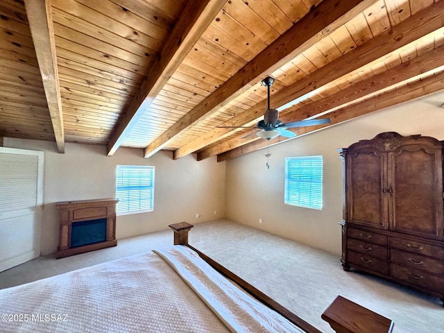 10487 E Turkey Creek Rd, Pearce, AZ 85625 - unfurnished bedroom featuring light colored carpet, a wooden ceiling with exposed beams, a fireplace, and a ceiling fan