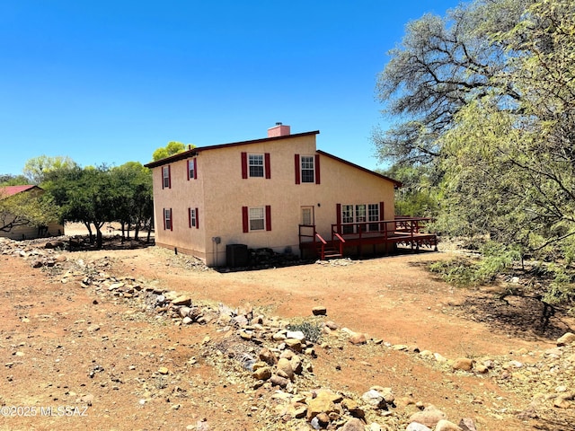 10487 E Turkey Creek Rd, Pearce, AZ 85625 - view of side of home featuring a wooden deck, a chimney, and crawl space