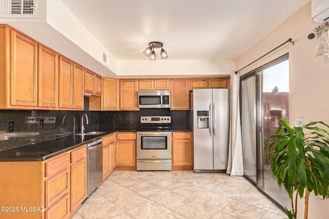 1312 S Avenida Polar Unit A6, Tucson, AZ 85710 - kitchen featuring appliances with stainless steel finishes, a wall mounted AC, and decorative backsplash