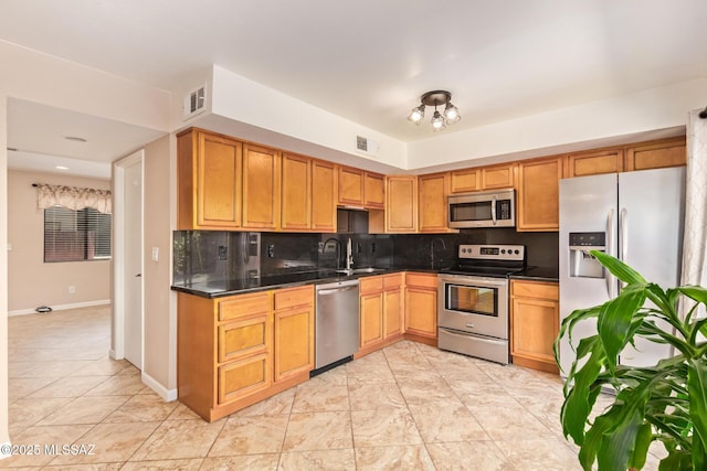 1312 S Avenida Polar Unit A6, Tucson, AZ 85710 - kitchen with stainless steel appliances, dark countertops, and tasteful backsplash