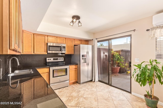 1312 S Avenida Polar Unit A6, Tucson, AZ 85710 - kitchen featuring stainless steel appliances, dark countertops, an AC wall unit, and tasteful backsplash
