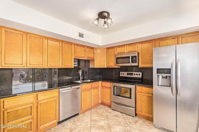 1312 S Avenida Polar Unit A6, Tucson, AZ 85710 - kitchen with appliances with stainless steel finishes, backsplash, and dark countertops