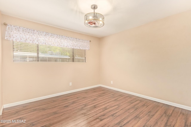 1312 S Avenida Polar Unit A6, Tucson, AZ 85710 - empty room with wood finished floors and a chandelier