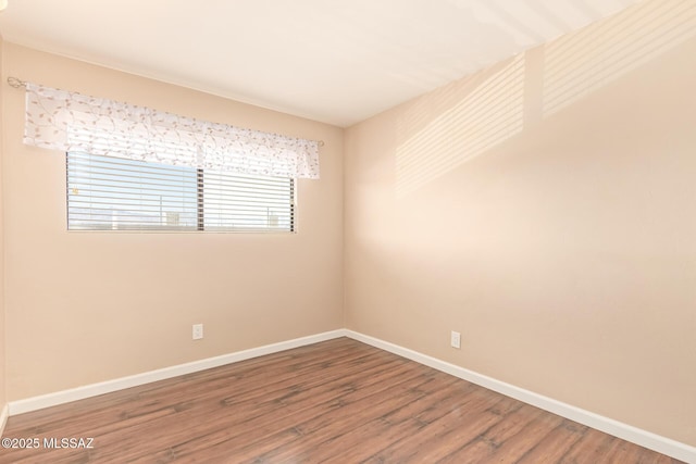 1312 S Avenida Polar Unit A6, Tucson, AZ 85710 - unfurnished room with baseboards and wood finished floors