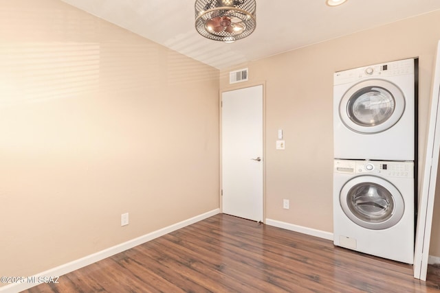 1312 S Avenida Polar Unit A6, Tucson, AZ 85710 - washroom with stacked washing machine and dryer, dark wood-type flooring, and a chandelier