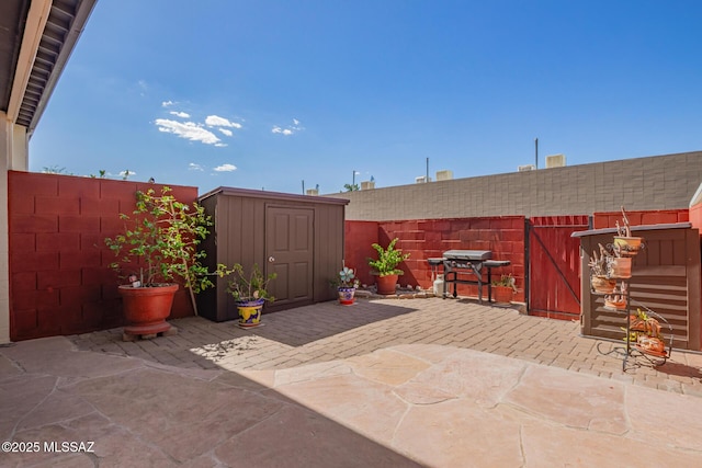 1312 S Avenida Polar Unit A6, Tucson, AZ 85710 - fenced backyard with a patio area, a storage unit, and area for grilling