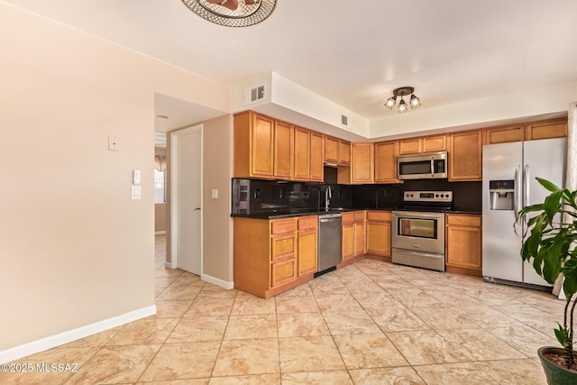 1312 S Avenida Polar Unit A6, Tucson, AZ 85710 - kitchen with stainless steel appliances, dark countertops, and decorative backsplash