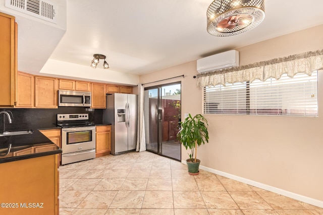 1312 S Avenida Polar Unit A6, Tucson, AZ 85710 - kitchen featuring appliances with stainless steel finishes, a wall unit AC, dark countertops, and backsplash