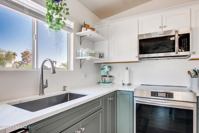6075 N Applesauce Ct, Tucson, AZ 85741 - kitchen with appliances with stainless steel finishes, open shelves, healthy amount of natural light, and white cabinetry