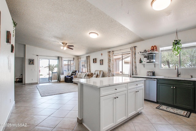 6075 N Applesauce Ct, Tucson, AZ 85741 - kitchen with dishwasher, a textured ceiling, vaulted ceiling, light countertops, and light tile patterned floors