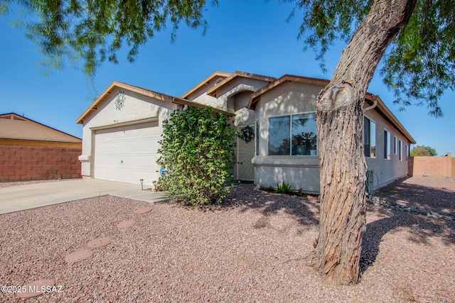 6075 N Applesauce Ct, Tucson, AZ 85741 - ranch-style house featuring concrete driveway, stucco siding, and an attached garage