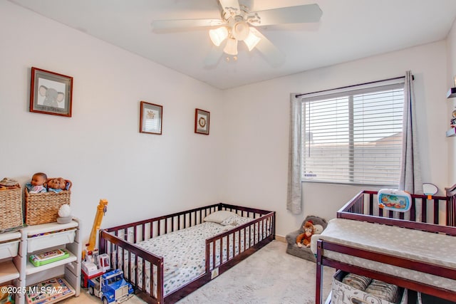 6075 N Applesauce Ct, Tucson, AZ 85741 - bedroom with carpet, a nursery area, and a ceiling fan