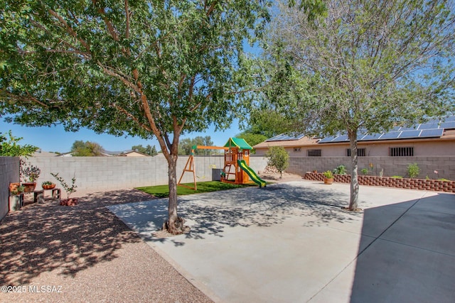 6075 N Applesauce Ct, Tucson, AZ 85741 - fenced backyard with a playground and a patio area