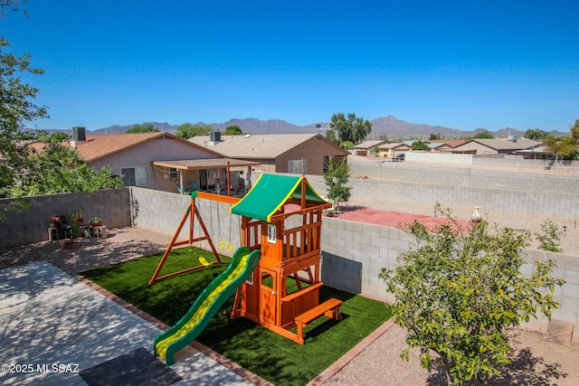 6075 N Applesauce Ct, Tucson, AZ 85741 - view of playground featuring a mountain view, a residential view, a fenced backyard, and a patio