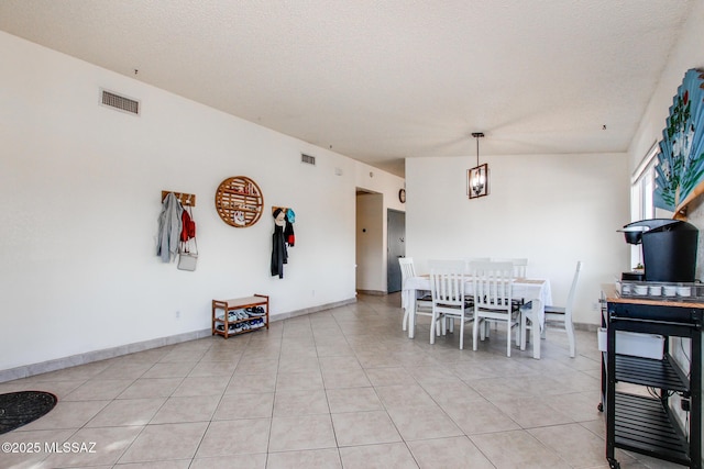 6075 N Applesauce Ct, Tucson, AZ 85741 - dining room featuring light tile patterned floors, a textured ceiling, and a chandelier