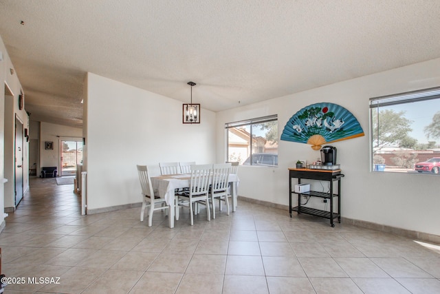 6075 N Applesauce Ct, Tucson, AZ 85741 - dining room featuring light tile patterned floors, a textured ceiling, and vaulted ceiling