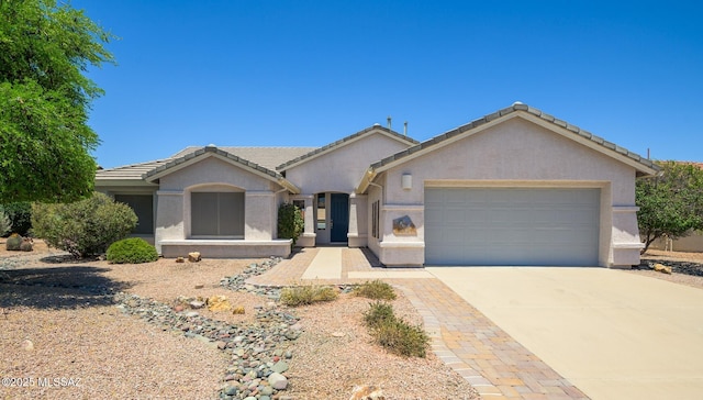 1149 N Desert Deer Pass, Green Valley, AZ 85614 - single story home with a garage, stucco siding, concrete driveway, and a tile roof