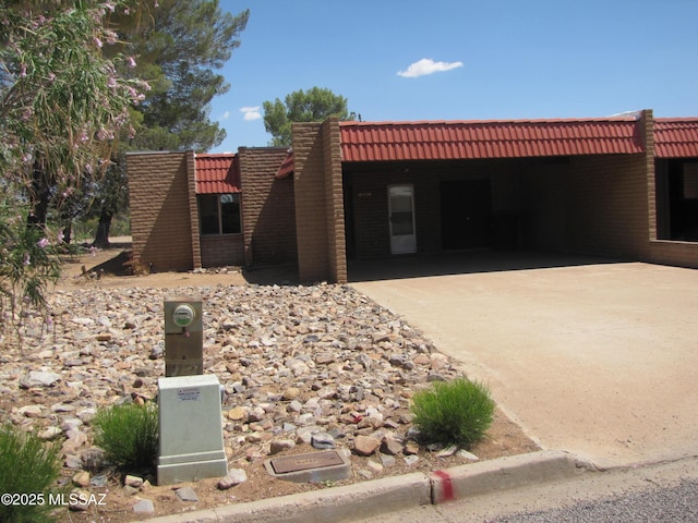 1001 E Irene St, Pearce, AZ 85625 - view of front facade with driveway, an attached carport, and a tile roof