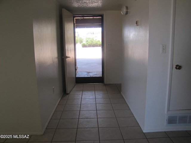 1001 E Irene St, Pearce, AZ 85625 - hallway featuring light tile patterned floors and a textured ceiling