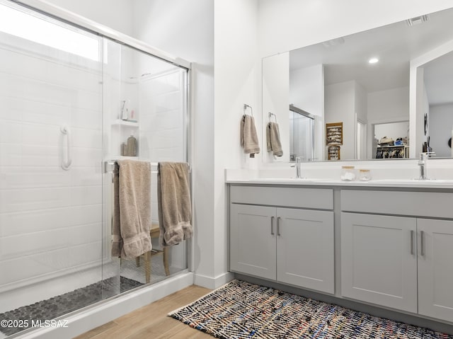 656 W Wilkinson St, Corona De Tucson, AZ 85641 - full bathroom featuring a shower stall, wood finished floors, and double vanity