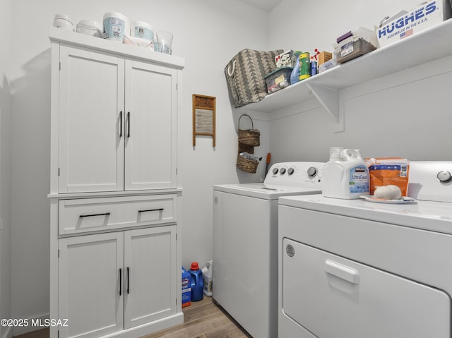 656 W Wilkinson St, Corona De Tucson, AZ 85641 - washroom featuring washing machine and clothes dryer, light wood-style floors, and cabinet space