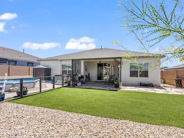 656 W Wilkinson St, Corona De Tucson, AZ 85641 - back of house featuring a storage unit, a fenced backyard, a patio, stucco siding, and roof with shingles