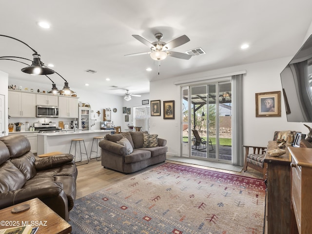 656 W Wilkinson St, Corona De Tucson, AZ 85641 - living room with a ceiling fan, recessed lighting, and light wood-style floors