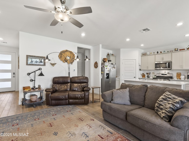 656 W Wilkinson St, Corona De Tucson, AZ 85641 - living area with light wood-style flooring, ceiling fan, and recessed lighting