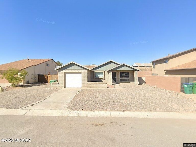 4570 W Dunn Pl, Tucson, AZ 85741 - ranch-style home featuring a garage, concrete driveway, and brick siding