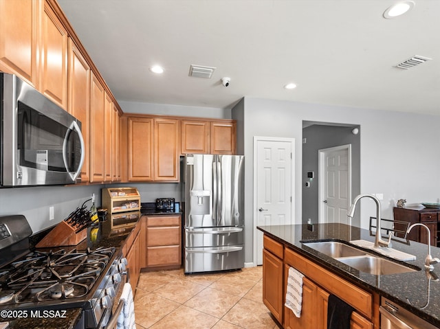 11471 E Squash Blossom Loop, Tucson, AZ 85747 - kitchen featuring appliances with stainless steel finishes, dark stone counters, light tile patterned floors, recessed lighting, and brown cabinetry