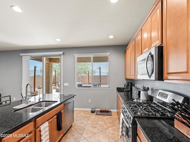11471 E Squash Blossom Loop, Tucson, AZ 85747 - kitchen with stainless steel appliances, recessed lighting, dark stone counters, and light tile patterned flooring