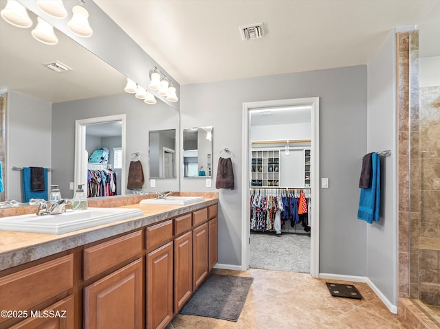 11471 E Squash Blossom Loop, Tucson, AZ 85747 - full bathroom with double vanity, a walk in closet, a tile shower, and tile patterned flooring