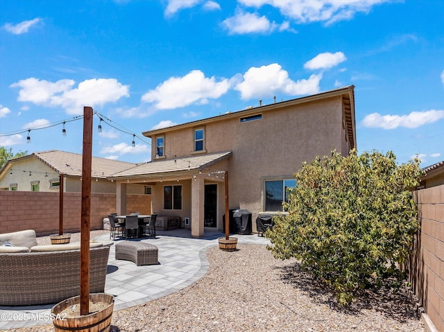 11471 E Squash Blossom Loop, Tucson, AZ 85747 - rear view of property featuring stucco siding, a fenced backyard, and a patio area