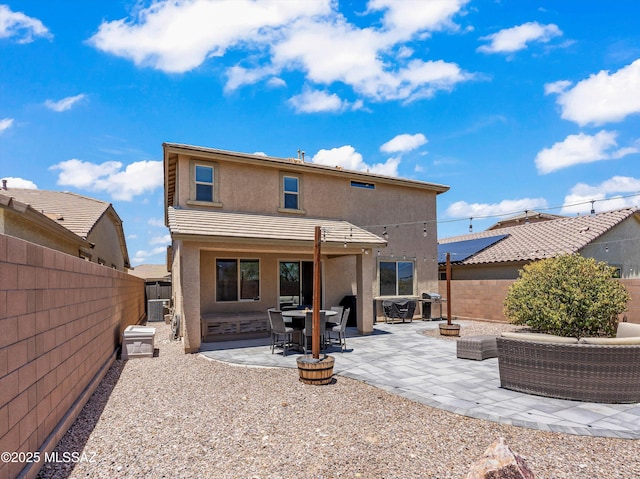 11471 E Squash Blossom Loop, Tucson, AZ 85747 - back of property featuring stucco siding, a fenced backyard, a patio, and an outdoor living space