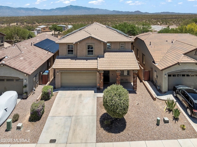 11471 E Squash Blossom Loop, Tucson, AZ 85747 - view of front of property featuring stucco siding, driveway, a mountain view, stone siding, and an attached garage