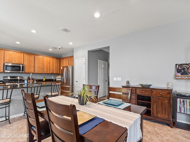 11471 E Squash Blossom Loop, Tucson, AZ 85747 - dining room with recessed lighting and light tile patterned floors