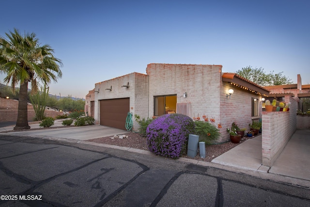 2000 E Campbell Ter, Tucson, AZ 85718 - view of front facade featuring concrete driveway, a garage, and a tile roof