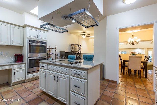 2000 E Campbell Ter, Tucson, AZ 85718 - kitchen with double oven, a ceiling fan, light tile patterned flooring, and a kitchen island
